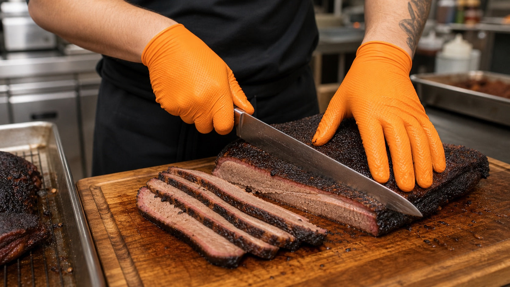 Orange textured nitrile gloves used for brisket slicing and portioning